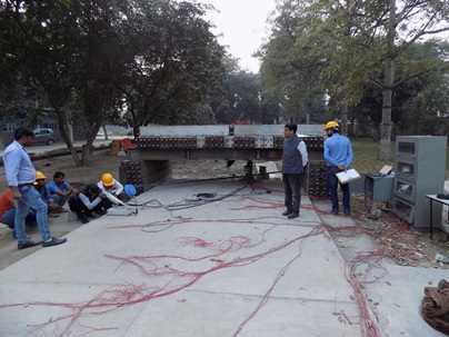 Load testing and monitoring of stresses developed in experimental Low Volume Traffic Concrete Pavement stretch made using C&D waste